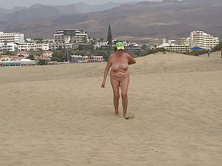 Mature Woman Walking On The Beach Naked